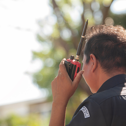 Security guard on walkie talkie from a NC commercial security systems provided by Protection Systems, Inc.